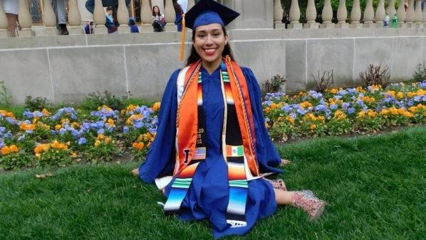 Smiling graduate wearing her cap and gown